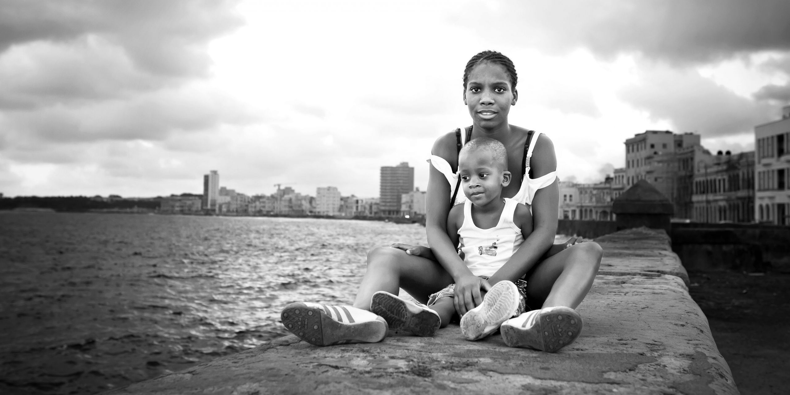 'On the Edge' by Diana Bejarano Mother and child portrait at the Malecón in La Habana, Cuba.